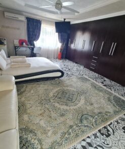 Beulah Presidential Suite luxury bedroom with king-size bed and elegant lighting at Quereba Bed and Breakfast Mafikeng.