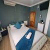 Sapphire Standard Suite cool blue bedroom with modern furniture and calm lighting at Quereba Bed and Breakfast Mafikeng.
