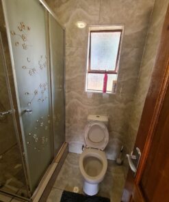 Star Ruby Suite bathroom with polished tiles and modern layout at Quereba Guesthouse Mafikeng.