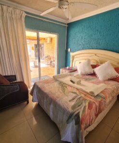 Quartz Standard Suite colorful bedroom with lively tones and pool access at Quereba Bed and Breakfast Mafikeng.