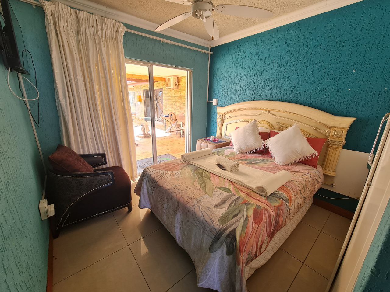 Quartz Standard Suite colorful bedroom with lively tones and pool access at Quereba Bed and Breakfast Mafikeng.