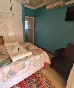 Quartz Standard Suite colorful bedroom with lively tones and pool access at Quereba Bed and Breakfast Mafikeng.