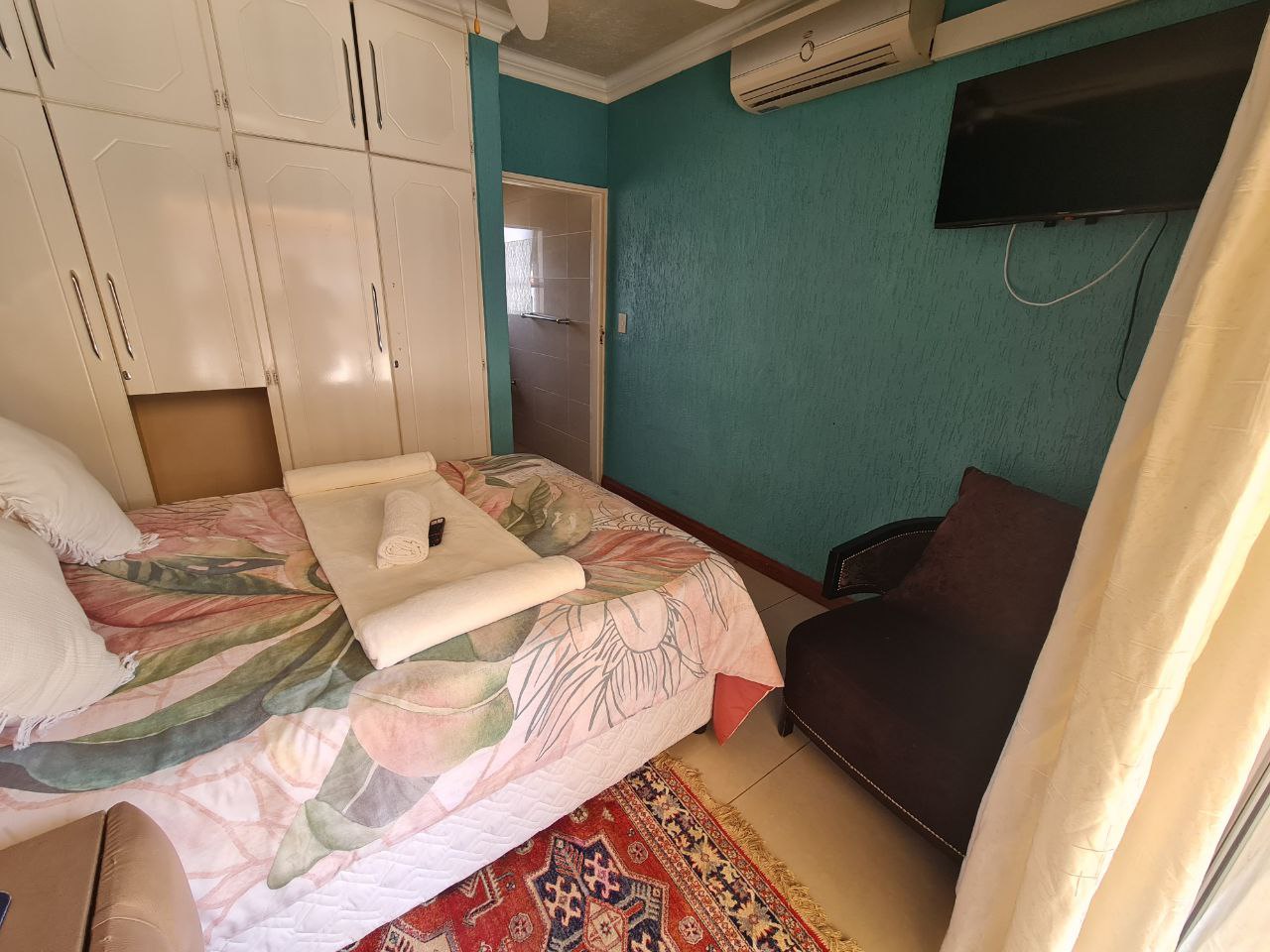Quartz Standard Suite colorful bedroom with lively tones and pool access at Quereba Bed and Breakfast Mafikeng.