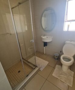 Quartz Suite bathroom with bright walls and simple modern style at Quereba Guesthouse Mafikeng.