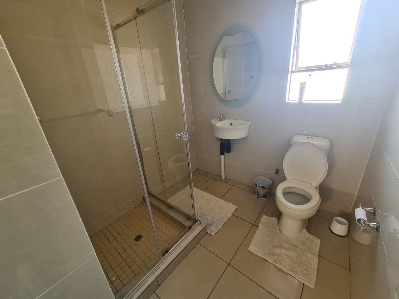 Quartz Suite bathroom with bright walls and simple modern style at Quereba Guesthouse Mafikeng.