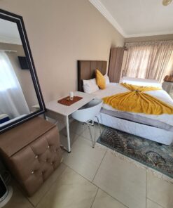 Onyx Family Suite large family bedroom with twin and double beds overlooking garden area at Quereba Bed and Breakfast Mafikeng.