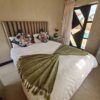 Garnet Standard Suite cozy bedroom with warm colors and garden-side view at Quereba Bed and Breakfast Mafikeng.