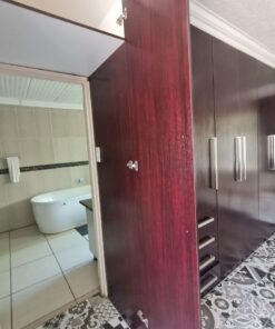 Beulah Presidential Suite bathroom with marble finishes and large vanity inside Quereba BnB Mafikeng.