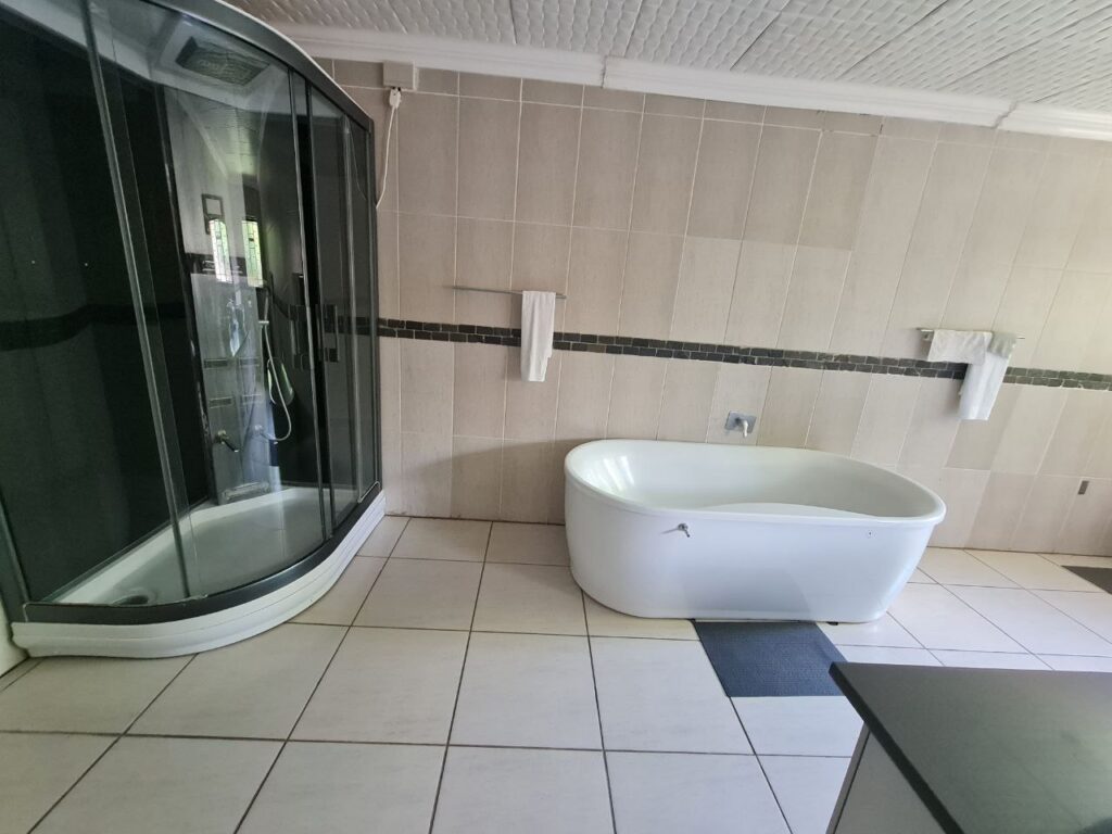 Beulah Presidential Suite bathroom with marble finishes and large vanity inside Quereba BnB Mafikeng.