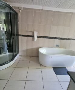 Beulah Presidential Suite bathroom with marble finishes and large vanity inside Quereba BnB Mafikeng.